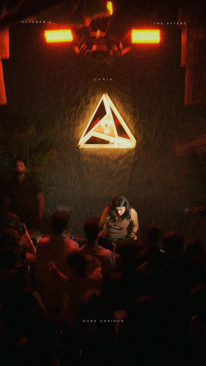 U4RIA neon triangle motif — the venue centerpiece